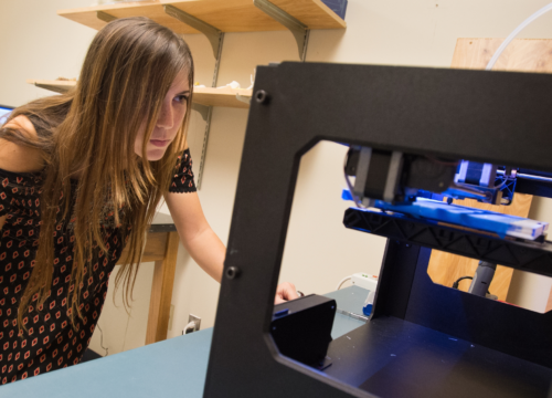 Graduate student Maddeline Voas 3D prints a sacrum with spina bifida at the University of West Florida in Pensacola, Florida.