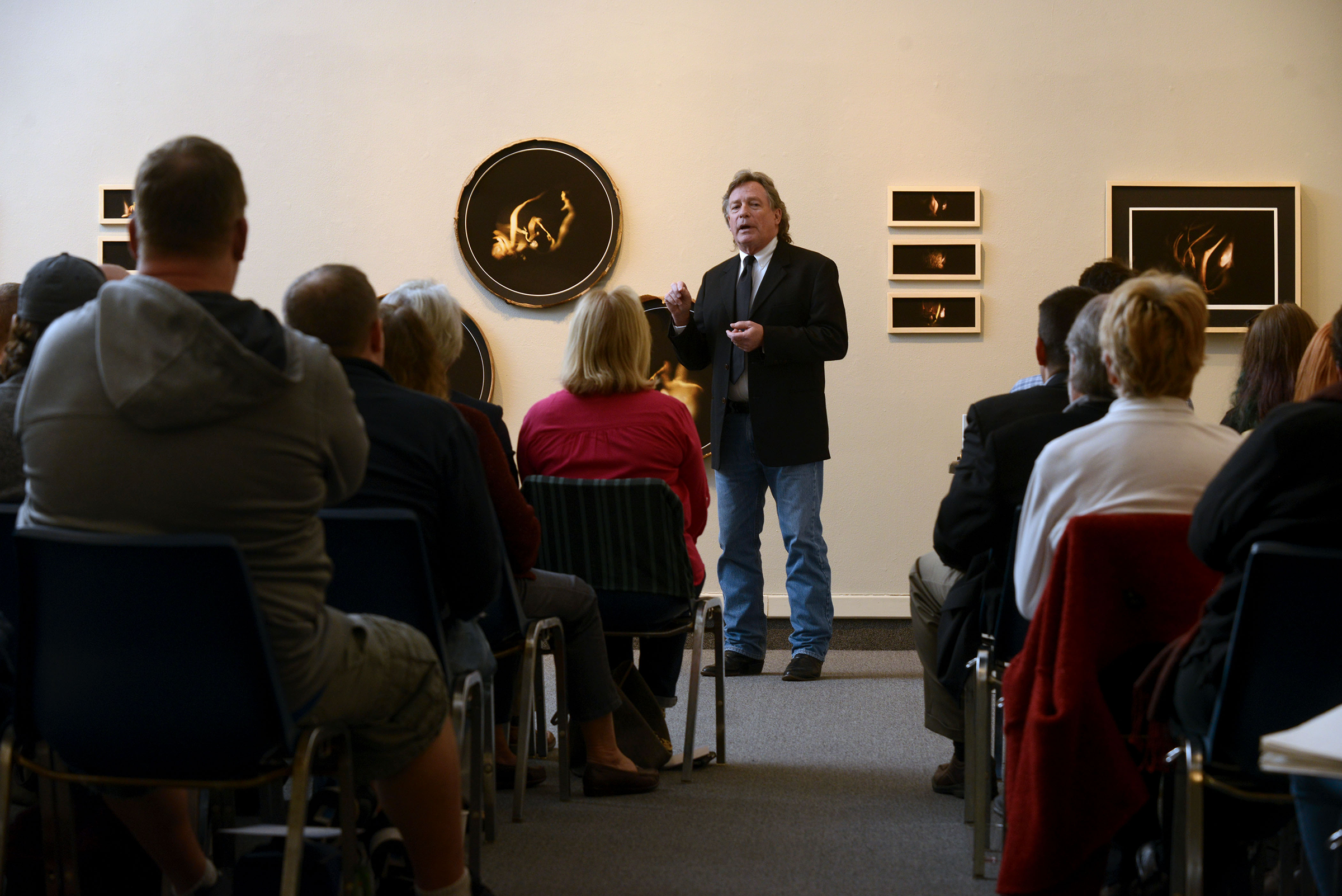 Dr. Jim Jipson speaks to crowd during the Rite of Passage lecture series at The Art Gallery at UWF.