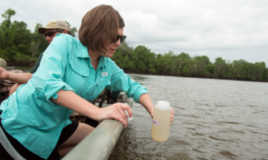 Assistant Professor Dr. Alexis Janosik samples water from Smith Lake for Environmental DNA of Gulf and Alabama Sturgeon.