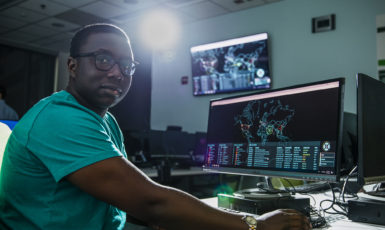 UWF student Basil Kuloba in the Cybersecurity Battle Lab in the Science and Engineering Building, Building 4.