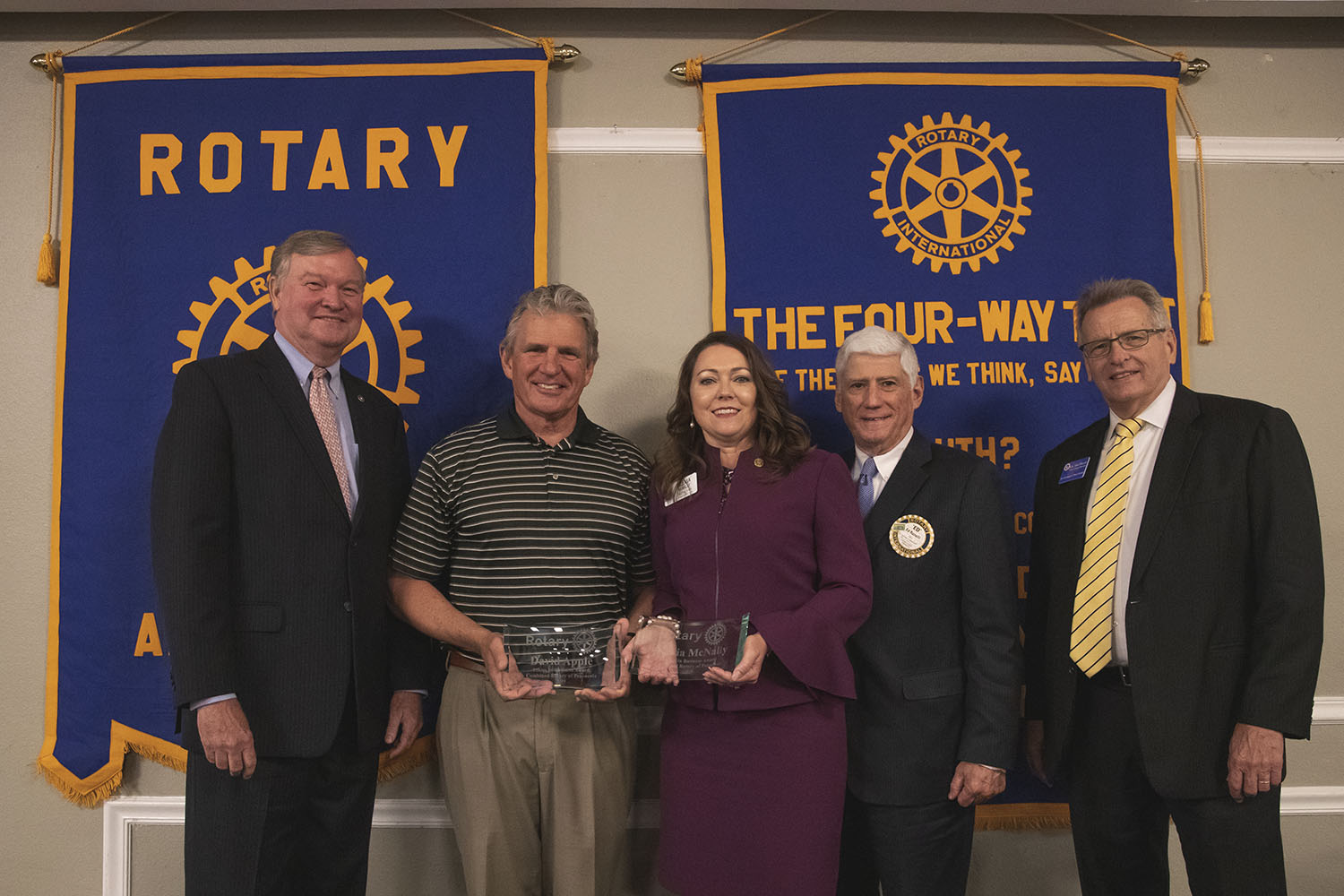 Olevia McNally and David Apple, recipients of the 2019 Ethics in Business Awards, posing for a photo with rotary leaders during the seventeenth annual event held on May 6 at New World Landing in Downtown Pensacola.