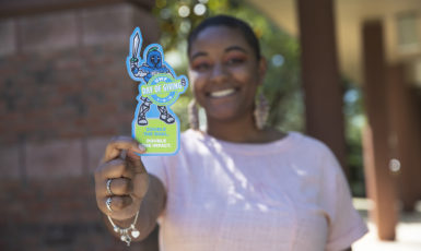 UWF student holds Argie cut-out in honor of Day of Giving during UWF Founders Week