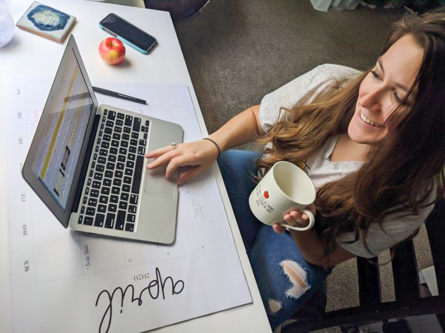 UWF student teacher working on her laptop to teach remotely