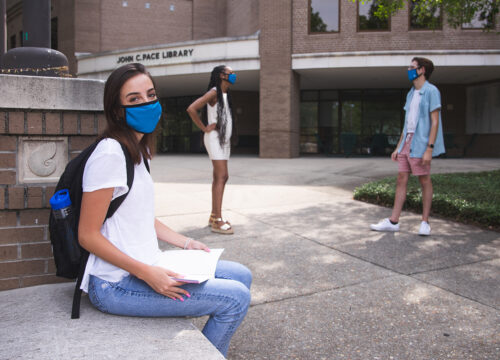 UWF students venture about campus while wearing face protection on Aug. 19, 2020.