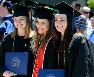 UWF students posing for photo outside during graduation at the Civic Center.