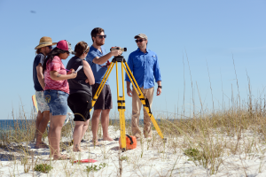Dr. Phillip Schmutz teaches students to use a line level to document elevation while mapping. 