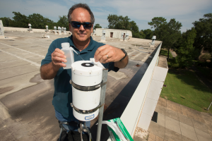 Dr. Wade H Jeffrey Professor & Director at the Center for Environmental Diagnostics & Bioremediation cleans a solar radiometer at the University of West Florida. 
