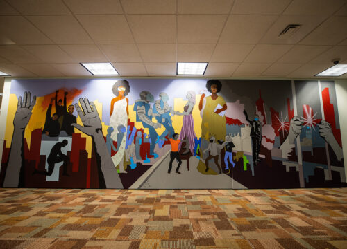 Process photos and final images of UWF resident artist Marzia Ransom's Black Lives Matter mural.