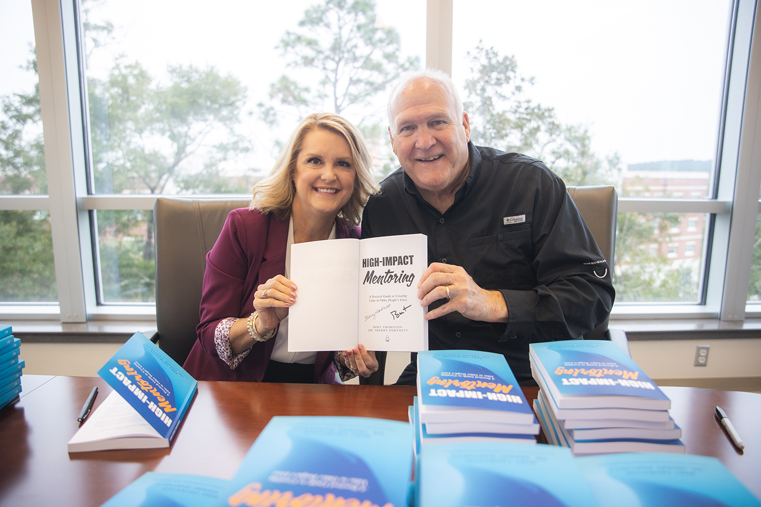 Dr. Sherry Hartnett, Director of the UWF Department of Commerce, and Bert Thornton, Entrepreneur in Residence, with thier new book "High-Impact Mentoring" on Nov. 4, 2021.
