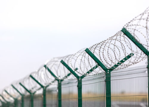 Security with a barbed wire fence. Fencing of sensitive sites with barbed wire