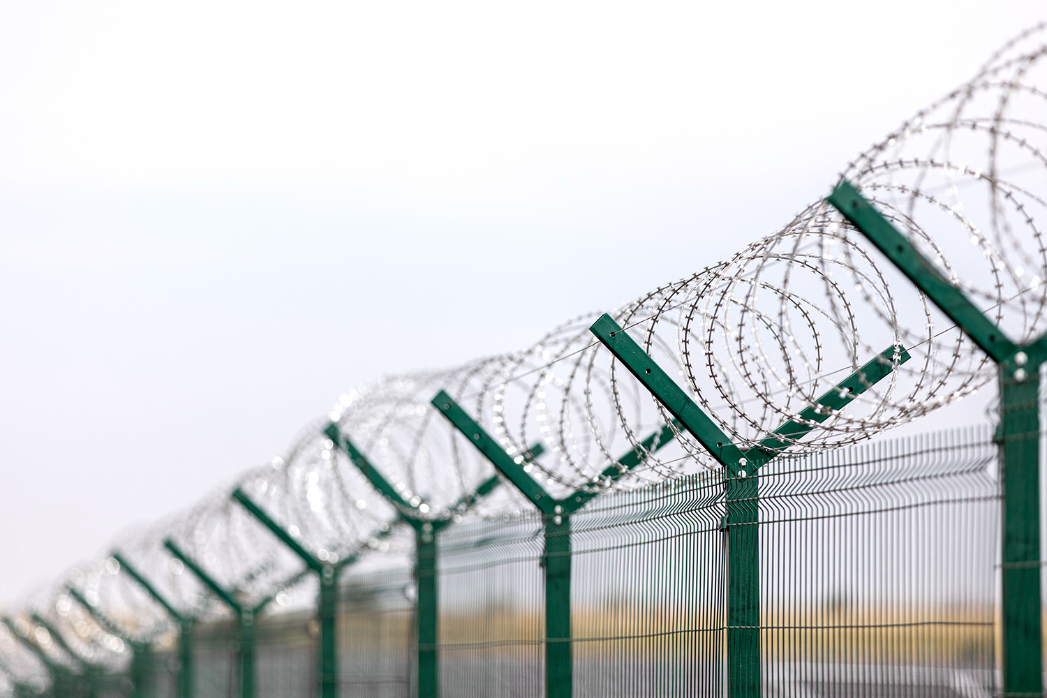 Security with a barbed wire fence. Fencing of sensitive sites with barbed wire