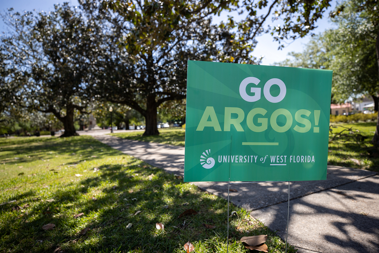 UWF kicks off Founders Week 2021 by placing blue and green signs on campus and around Pensacola.