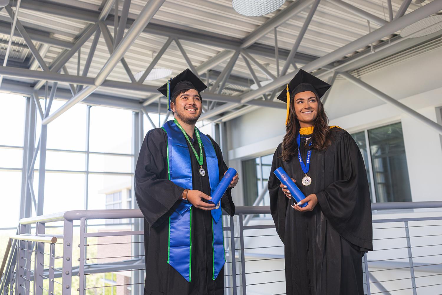 UWF students pose in their graduation regalia on the Pensacola campus on April 22, 2022.