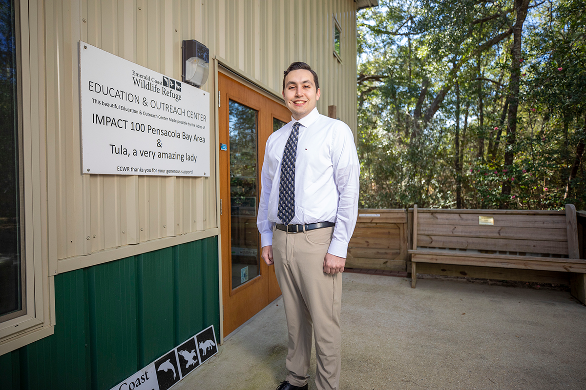 UWF graduate James Barnes stands in front of Emerald Coast Wildlife Rescue Education and Outreach Center