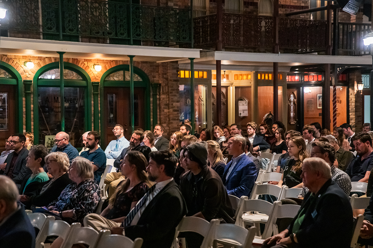 Guests sit in the audience at a lecture series at the Pensacola Museum of Commerce