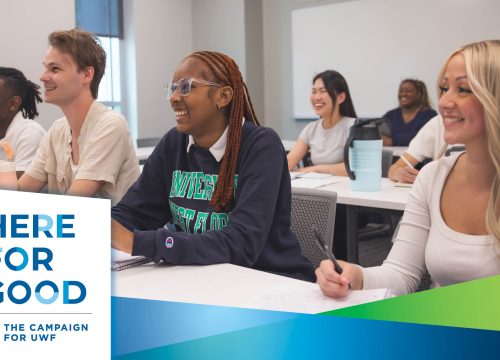 Students sit in a classroom smiling with a Here for Good graphic overlaid