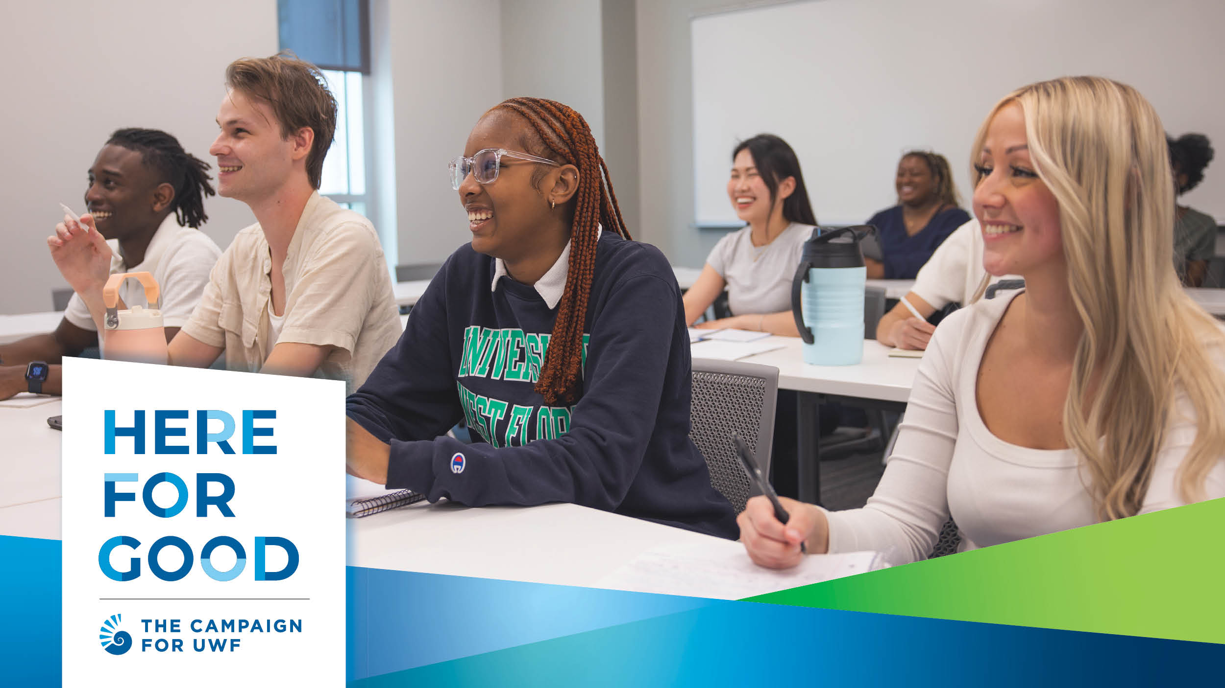 Students sit in a classroom smiling with a Here for Good graphic overlaid
