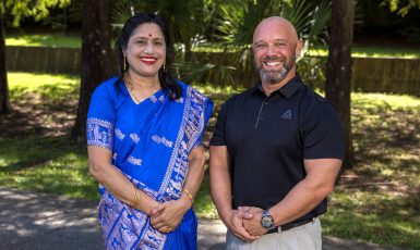 Dr. Bagui and Dr. Crow pose side by side in an outdoor setting.