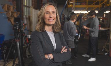 Dr. Kristen "Brent" Venable poses with arms crossed in ISR lab