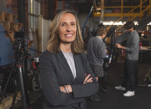 Dr. Kristen "Brent" Venable poses with arms crossed in ISR lab