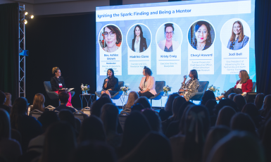 Photo: Four panelists and a moderator sit on stage while a crowd looks on. Screen behind them reads, "Igniting the Spark: Finding and Being a Mentor. Rev. Ashlee Brown, Madrina Ciano, Kristy Craig, Cheryl Howard, Jodi Bell."