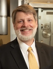 Dr. Eric Bostwick indoor portrait in a suit.