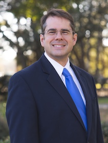 Dr. James Mead outdoor portrait in a suit.
