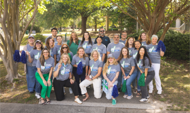 Photo: Group of UWF employees wearing matching UWF Day of Giving grey t-shirts.
