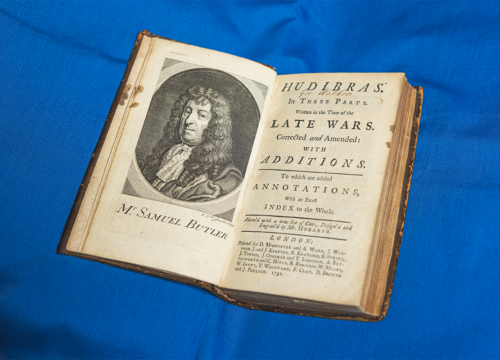Vintage book sits open on a blue tablecloth.