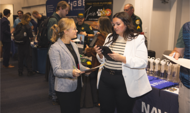 A student and employer interact at a career fair.